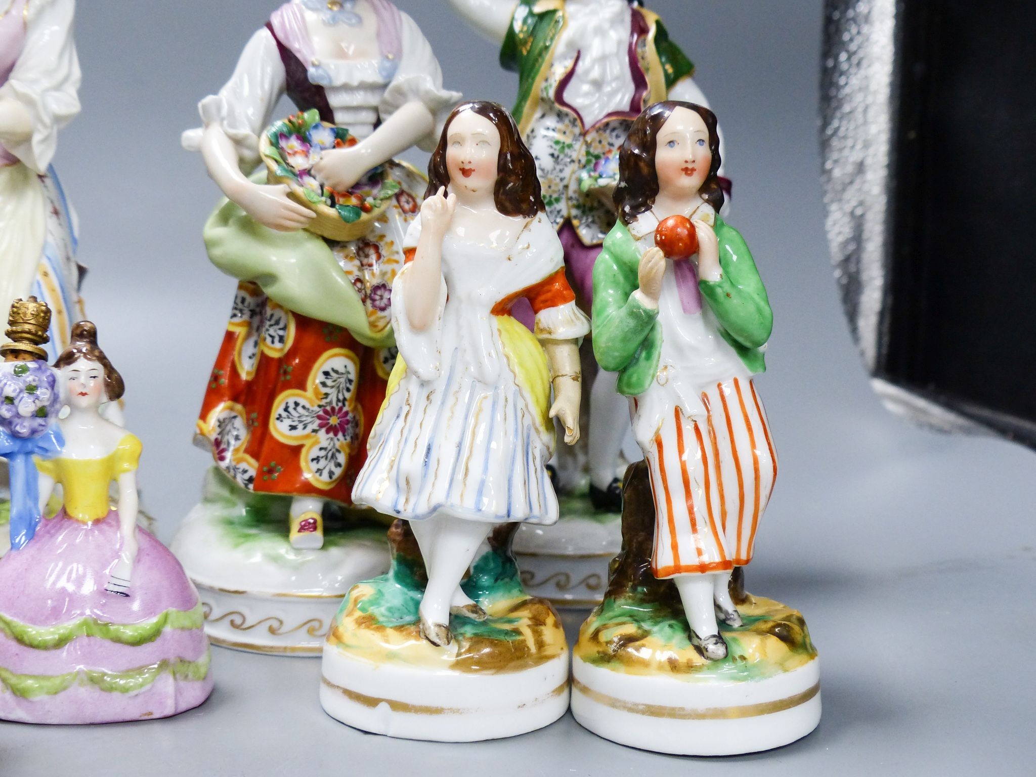 Ten Continental porcelain figures or groups, 19th/20th century, including a Berlin figure of a gentleman, tallest 23 cm